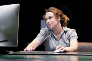 woman working on the computer and talking on the phone