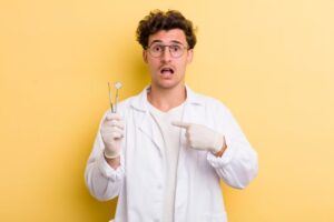 shocked dentist pointing to himself