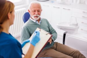 older man talking with team member about cost